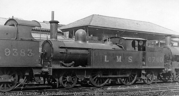 With an 0-8-0 in front and an 0-6-0 behind, 5'6" 1P 2-4-2T No. 6740 awaits its fate at Crewe Works in 1948. These 2-4-2Ts had been common motive power on LNW branch lines in the previous 50 years or so. A line of locomotives awaiting scrapping seems to have been near the Iron Foundry, but I am uncertain of the precise location in the Works complex.