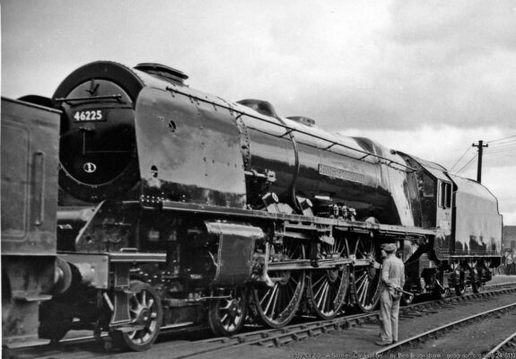 Outside the Paint Shop at the great Crewe Works, 4-6-2 No. 46225 'Duchess of Gloucester', stands one of the earlier of Sir William Stanier's incomparable design, introduced in streamlined form in 1937, de-streamlined in 1947. Is the man admiring his handiwork?