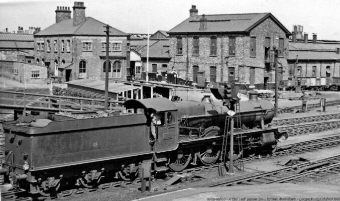 View NW from the footbridge leading into the Depot. A relative outsider in this stronghold of the former LNWR, ex-GW 4-6-0 No. 4986 'Aston Hall' (built 1/31, withdrawn 5/62) is passing on the Down Through No. 1 line. GW locomotives, which worked into Crewe on the line from Wellington via Nantwich were normally serviced at Gresty Lane Depot to the SW of Crewe station, but this one seems to be visiting the LMS (ex-LNW) Crewe North Depot.