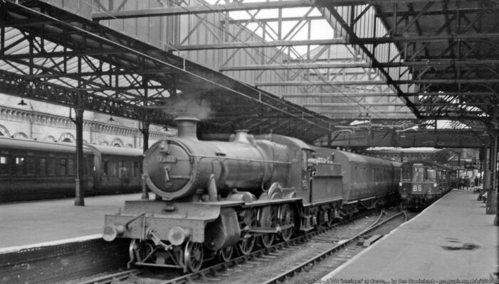 View northward to Bay Platform 3 at Crewe Station. A stopping train to Wellington via Market Drayton (ex-GW line branching off at Nantwich) is headed by 4-6-0 No. 7802 'Bradley Manor' (built 1/38, withdrawn 10/65 and preserved, being currently in active service on the Severn Valley Railway). In Bay Platform 4 is a dreary DMU, perhaps headed for Shrewsbury.