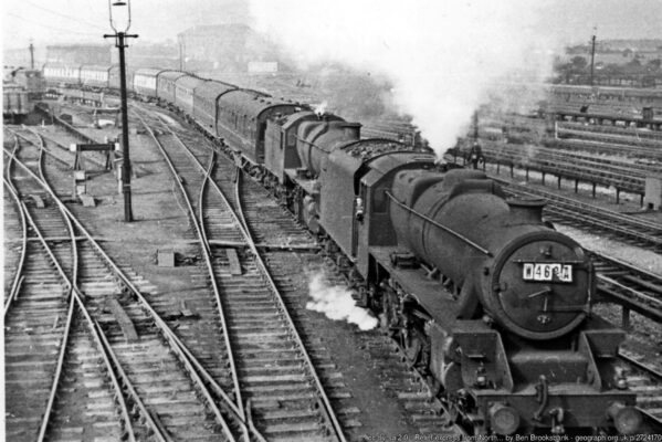 EView northward, towards the North by the WCML, on the left towards Chester and to the right towards Manchester: ex-LNWR major junction. This Up train is seen from the footbridge crossing from the Chester line the other lines at Crewe North Junction and passing Crewe North Locomotive Depot; unseen underneath are the Independent Lines conveying most of the freight traffic. The 13.40 Llandudno - Derby is headed by Stanier 5MT 4-6-0 No. 45416 (built 1937, withdrawn 7/65) piloting Stanier 5MT 2-6-0 No. 42951 (built 1933, withdrawn 3/66);it will proceed from Crewe via Stoke-on-Trent.