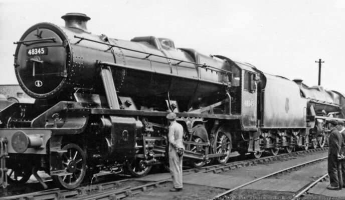Stanier 8F 2-8-0 No. 48345 (built early 1944, not withdrawn until 3/68) repainted after repair in 1958 - seems to be being admired. Behind it is 'Jubilee' 4-6-0 45685 'Barfleur'.