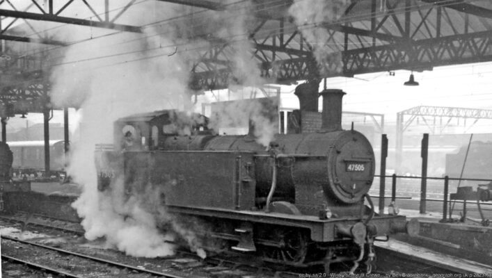 View NE at the south end of Crewe station, with one of the pilots seen at work, LMS Fowler 3F 0-6-0T No. 47505, which was built in 1928 as No. 16588 and withdrawn in 8/65 as a Crewe Works shunter. On a cold December day, electrification masts abound as the line to Manchester was already electric and that to Liverpool will be within the week.